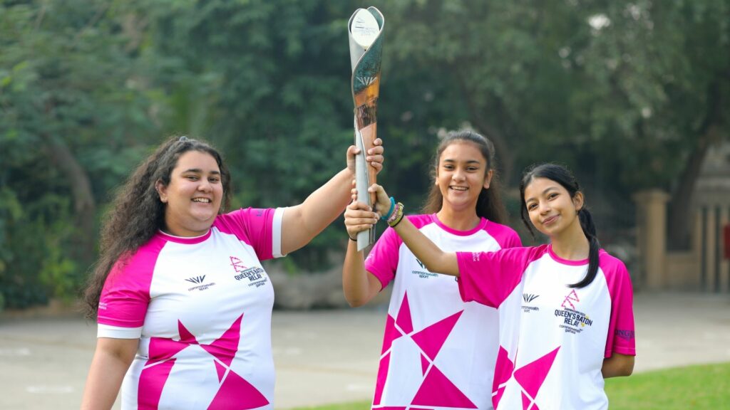 Three women holding the The Queen's Baton Relay in Pakistan