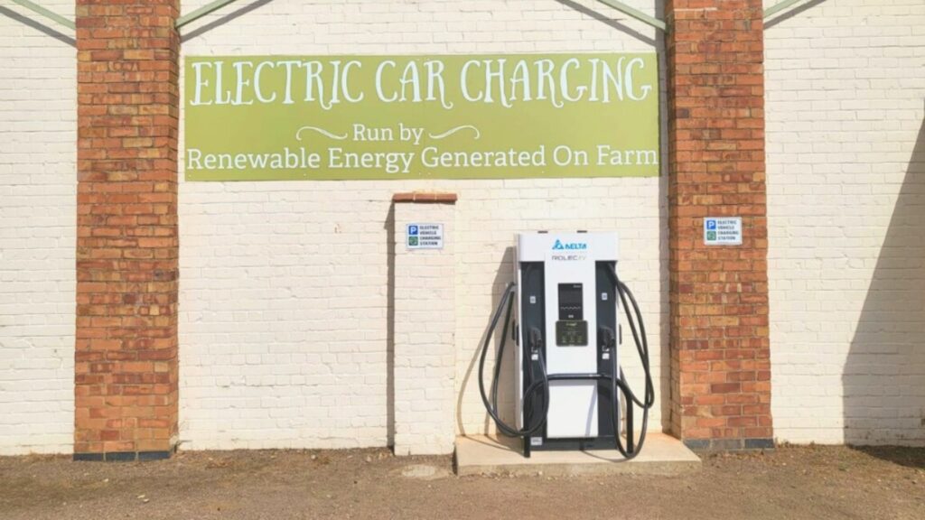 Electric Vehicle charging point with green signage above at Uncle Henry's Farm Shop