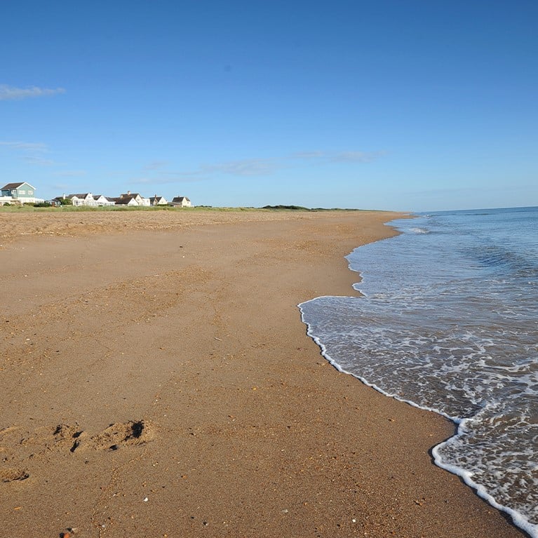Young girl running into the sea