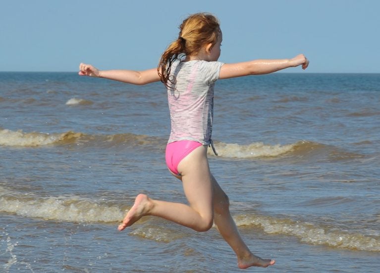 Clean is good blog header Young girl running into the sea